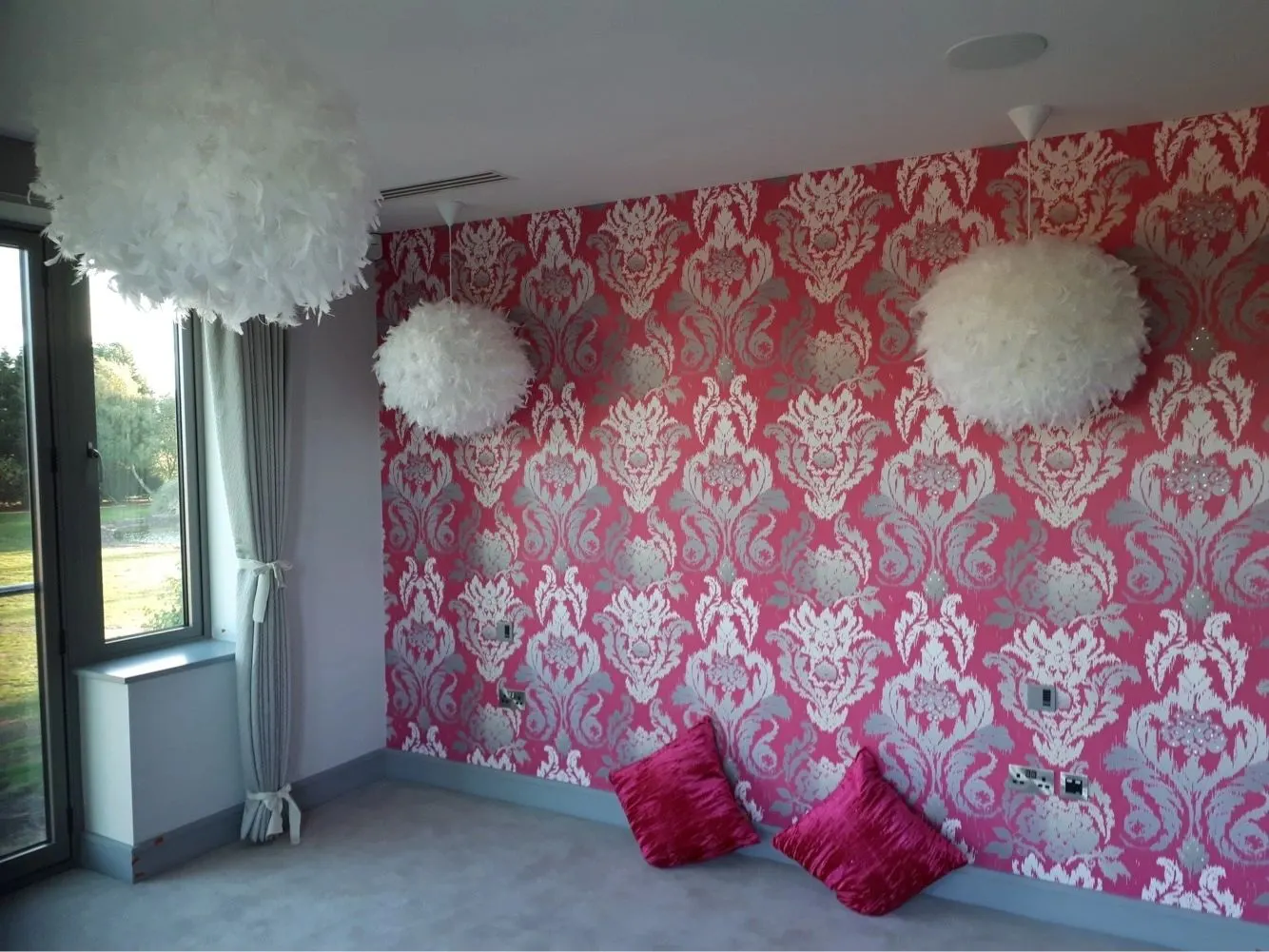 Pink damask feature wallpaper in a bright living space, Paul Crosby Decorators York