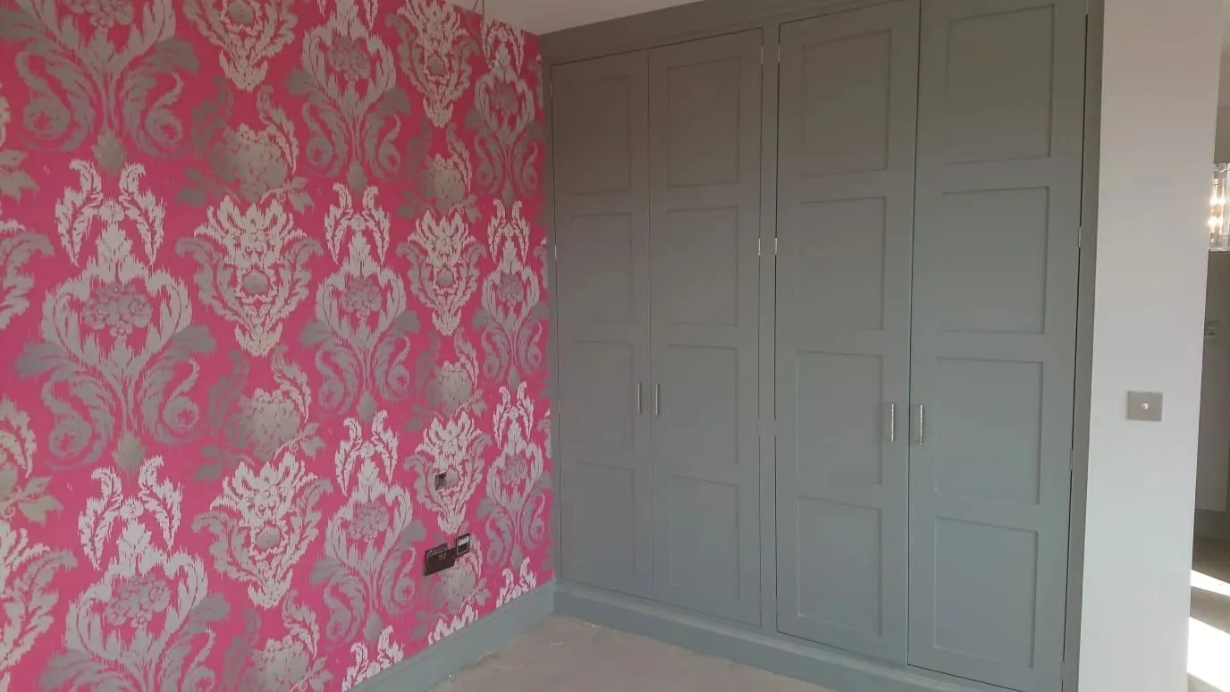 Damask wallpaper and painted fitted wardrobes, York
