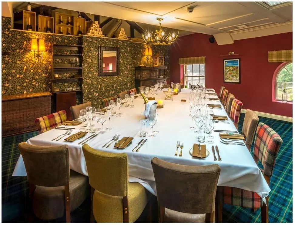 Private dining room with deep red walls decorated by Paul Crosby Decorators