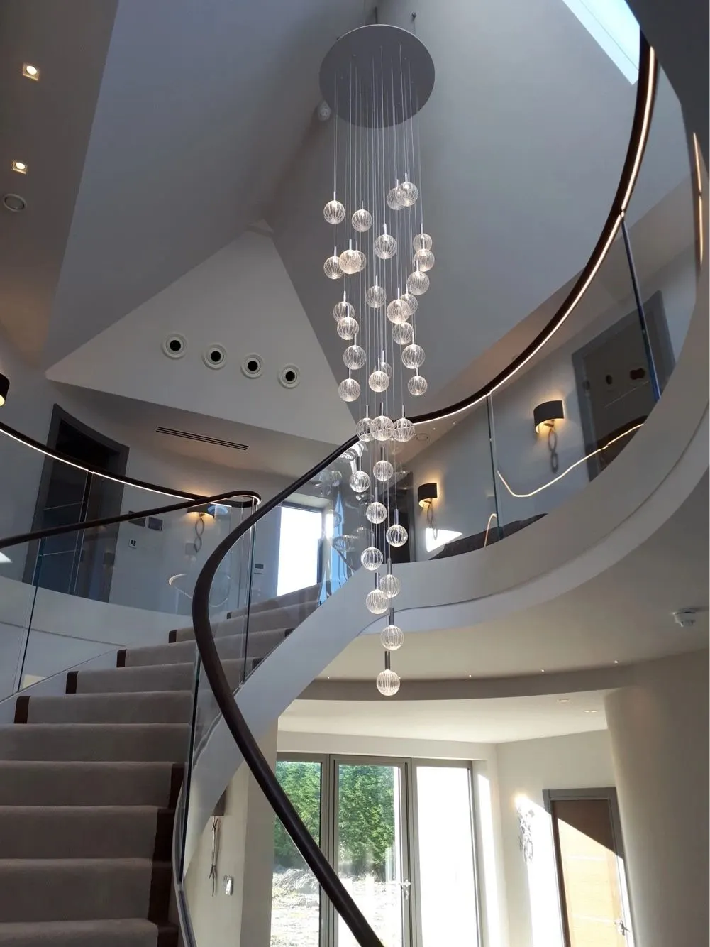 Spiral staircase and hallway decorated by Paul Crosby Decorators